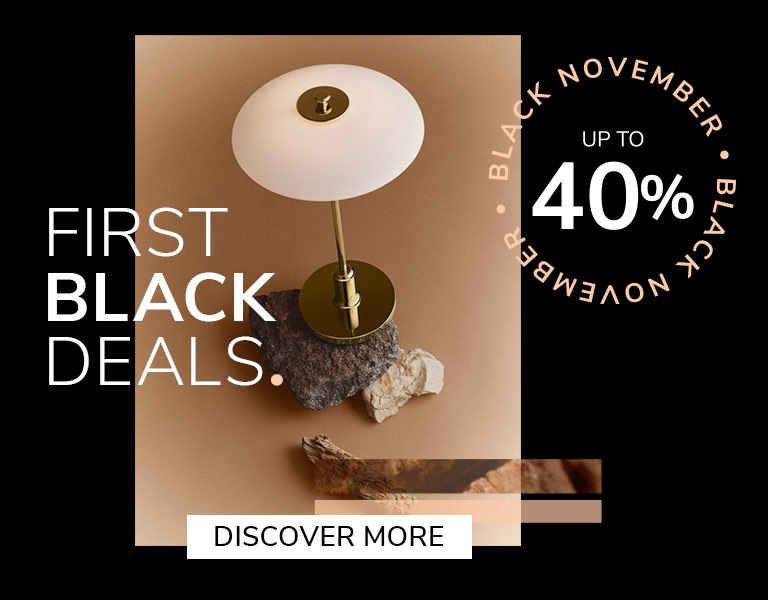 Discover More Elegant designer table lamp on natural stone base with gold stem and white shade, promoting Black November sale – up to 40% off with text ‘First Black Deals’ and ‘Discover More’ button.